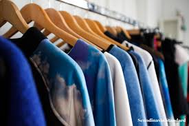 Clothing rack at store, emphasis on sale sign. Scandi Dandies Fashion Designer Ambra Fiorenza