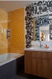 A wall mount tv hangs above the glass front cabinet that's topped with a beige granite countertop. 23 Yellow Tile Design Ideas For Your Kitchen Bath Sebring Design Build