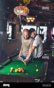 Gay couple playing billiards together, having fun Stock Photo - Alamy