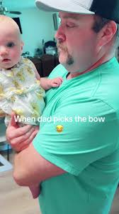 Dad Makes Fun of Baby with Big Bow