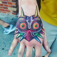 Okina mask tattoos are generally done in the traditional japanese tattoo style with bold lines to accentuate the details. 50 Majora S Mask Tattoo Designs For Men The Legend Of Zelda Ideas