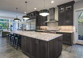 With a combination of white cabinets and gray countertop and stone backsplash for the main cabinets and dark mahogany finish of the island and breakfast table area. Customwood4you