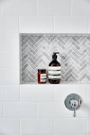 It's responsible for so much more. White Subway Tiles Frame A Gray Marble Herringbone Tiled Shower Niche Tile Shower Niche Bathrooms Remodel Bathroom Design