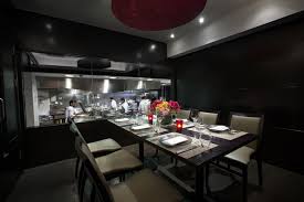 Chef S Table At Benares Restaurant Dark Room With Black Walls And A Window Looking Into A Restaurant K Chefs Table Luxury Restaurant Luxury Restaurants London