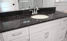 Whether in the kitchen or bathroom, black granite can make for the best backsplash tile material not only because of its functionality but also due to its the black emerald pearl countertop combining with the custom design and cut white marble backsplash tile works perfectly well as an accentuation. Granite Marble Quartz Countertops And More Black Pearl Granite Granite Bathroom Black Granite Countertops Granite Bathroom Countertops