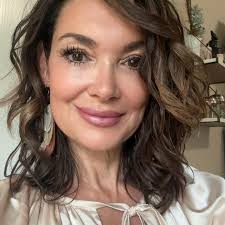 Should I keep or remove the tree growing against my house in NW Louisiana?