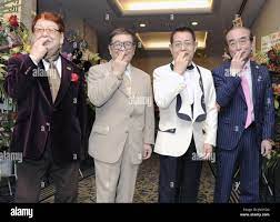 TOKYO, Japan - Members of the Drifters, (From L to R) Takagi Boo, Nakamoto  Koji, Kato Cha and Shimura Ken, pose for photos with Kato's trademark  gesture at a hotel in Tokyo,