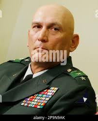 Former I Corps commander Lt. Gen. Stephen Lanza reacts as Chief of Staff of  the Army General Mark A. Milley, a Boston Red Sox fan, jokingly attempts to  sway his son, Raymond,