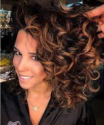 Light caramel brown hair color is a. Natural Black Hair With Curly Caramel Highlights Brown Hair Balayage Colored Curly Hair Black Hair Caramel Highlights