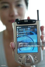 Eva Hui from Hewlett Packard poses with the new iPAQ pocket PC h5550...  News Photo