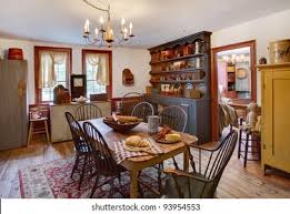 Achieve this look by furnishing your dining room with early american details like polished wooden furniture, tidy white decorations, a spacious jute rug. Image Dining Room Primitive Colonial Style Stock Photo Edit Now 93954553