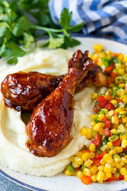 Slow Cooker Chicken Drumsticks Served With Mashed Potatoes And Corn Drumstick Recipes Slow Cooker Bbq Chicken Chicken Drumstick Recipes