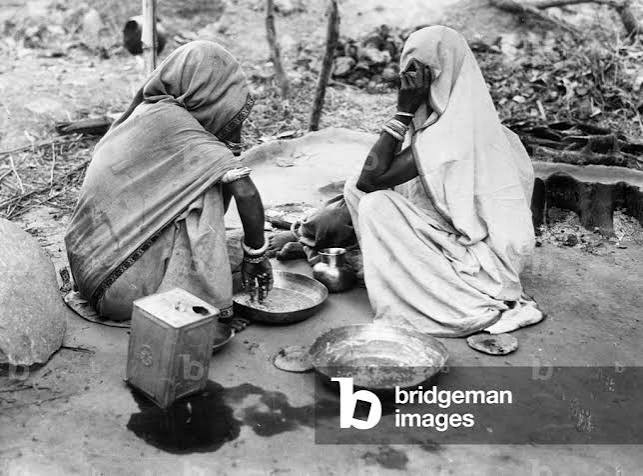 Image of Two Indian women having a meal, 1930 (b/w photo)