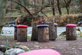 All those broken dishes and stumps from our tree removal have turned into a funky little side table in our kitchen garden. Table And Chairs Made From Tree Logs With Colorful Cushions Stock Photo Picture And Royalty Free Image Image 124034777
