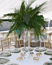 How Cool Are These Centerpieces By Vinnysplantsandflowers Floral Tropical Jungl Baby Shower Safari Theme Jungle Baby Shower Theme Safari Baby Shower Boy