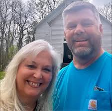 Are the brown rooster's comb and feathers typical of a rooster?