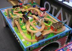 A crane lifts and lowers cargo onto the train and a helicopter soars over the town with blades spinning. 14 Best Thomas The Train Table Set Up Ideas Train Table Thomas The Train Table Thomas The Train