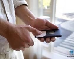 Image of Person using a fingerprint scanner to pay for something
