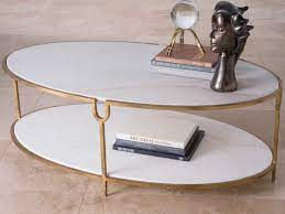 Crafted from iron with a burnished gold finish, our coffee table with its angular silhouette will bring a contemporary element to your interior. Global Views Antique Gold 52 Wide Oval Coffee Table Gv991786
