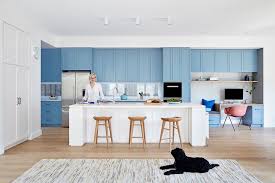 a wall of light blue kitchen cabinets
