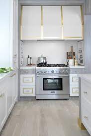 Range hoods are extremely helpful in keeping a modern kitchen clean. Gold Trim Kitchen Range Hood Modern Kitchen Hood Kitchen Vent Hood