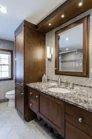 Lighter colors tend to work best with gray cabinets, but overall we're seeing more blues, greens and earth tones in interior design according to james t. Bathroom Remodel Dark Brown Cabinets Custom Soffit With Built In Lights Framed Mirror To Ma Bathrooms Remodel Bathroom Remodel Master Small Bathroom Remodel