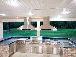 The limestone farmhouse sink is a salvaged piece and is surrounded by matching countertops. Why Do I Need An Outdoor Range Hood Our Favorite Hoods