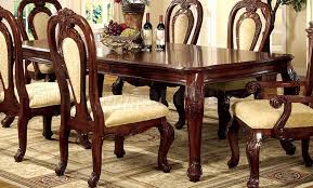 Formal dining table and chairs set, crafted from poplar solids and cherry veneers, featuring a double pedestal table with a 30 inch extension leaf, intricate carvings, and upholstered chairs with cabriole legs. Formal Dining Room Set W Dark Cherry Finish And Carving Details