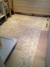 Adding interest to a tile floor is as simple as laying tiles diagonally instead of squared off with the wall. Mosaic Tiled Floor With Bathroom Installation In Leeds Wet Rooms Flooring Wooden Flooring