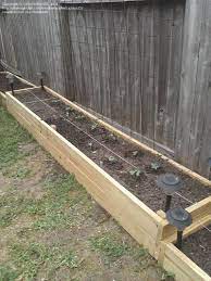 Raised bed with removable side fences. Fence Line Garden Use Of Lights And The Use Of Trellis Works Well Landscaping Along Fence Garden Ideas Along Fence Line Backyard Plants