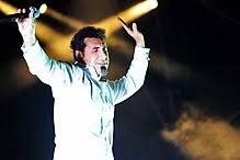 Apart from being known as the lead singer of this famous rock band, he is also the record producer of 'serjical strike records', musician, poet and political activist. Serj Tankian Wikipedia