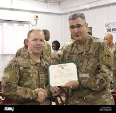 Sgt. Troy Melton, 184th Sustainment Command, receives an Army Achievement  Medal at Camp Arifjan, Kuwait, March 30, 2019. Melton received the award  for serving as the personnel accountability strength report noncommissioned  officer