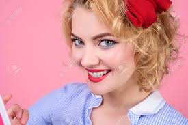 Golden highlights pop on darker hair. Retro Woman Pin Up Girl Beautiful Model Girl With Short Curly Hair And Red Lips Sensual Blond Girl With Makeup Pinup Beauty Fashion Cosmetics Vintage Style Woman With Fashion Style Makeup Stock