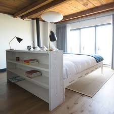 all of our rooms at timber cove are unique some of our ocean view rooms feature floating king beds whi bed in middle of room bedroom design wall behind bed