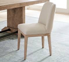 This piece features tapered wood legs for a subtle keter outdoor storage bench with backrest: Layton Upholstered Dining Chair Pottery Barn