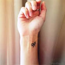Pretty ribbon tattoo with quote on thigh. 100 Terrific Bow Tattoos On Wrist