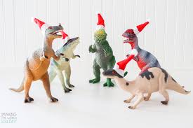 (i used my silhouette cameo) punch hole into wood slat. How To Make Funny Dinosaur Christmas Ornaments