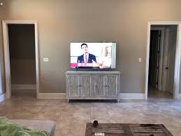 Here is living room with one drywall and one stone wall. Decorating Around Console And Tv