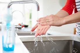 close up of woman washing hands in