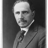 Sammy M. Baho assists Lt. Cmdr. Ralph Raya.