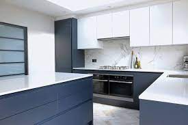 A soft blue has been used on the lower cabinets, as well as on and inside of some of the upper open box shelves to create a bright, welcoming kitchen. Dark Blue Handleless Kitchen With Copper Radiator Contemporary Kitchen Hertfordshire By Planet Furniture Houzz