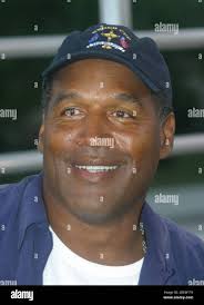 Plantation, FL 10-3-2002 OJ Simpson watches his 14 year old son Justin from  the bleachers playing football against American Heritage School. Justin is  a fullback with the Gulliver Preps Raiders, the JV