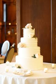 Traditional White Wedding Cake With Buttercream Frosting And Flowers Wedding Cakes White Wedding Cake Cake Servings