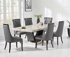 Chic blue and gray dining room dons a blue area rug sat beneath a salvaged wood dining table lit by an iron linear chandelier and seating cream nailhead dining chair s while board and batten lower walls are contrasted with gray dining paper framing long windows and slate blue pleated curtains cover patio doors. Raphael 170cm Cream And Black Pedestal Marble Dining Table With Angelica Chairs Gray Dining Chairs Dining Table Marble Marble Dining Table Set