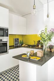 Unique gray backdrop and pops of yellow enliven this eclectic kitchen [from: 25 Vivacious Yellow Kitchen Decor Ideas Shelterness