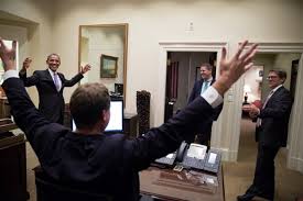 President Barack Obama tosses a football