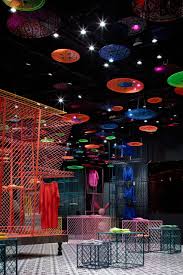 Clothing Rails Made From Pieces Of Colourful Metal Mesh Lengths Of Bamboo And Black Frames Define Different Zones Ins Store Design Retail Design Room Pictures