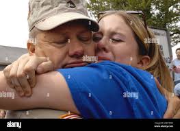 Brad Dillon hugs his daughter, Lindsie, after he and other members of the  Michigan National Guard 156th Signal Battalion returned from deployment in  Iraq, Saturday, May 8, 2004, in Adrian, Mich. (AP