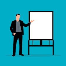 Businessman standing in front of a white board for a presentation.