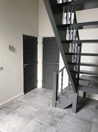 Hal Die Rust Uitstraalt Grijze Deuren In Witte Kozijnen En Grijze Trap Plinten En Kozijnen In Dezelfde Kleur Als Donkere Deuren Witte Kozijnen Deur En Kozijn